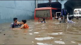 Terrifying moment Indian commuters forced to swim from bus submerged in floodwaters