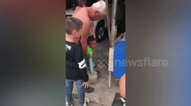 Toddler gets arm stuck in umbrella stand