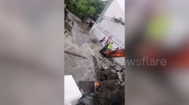 Dramatic moment families are rescued after storm washed away road next to their homes