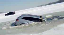 SUV captured sinking in ice hole with occupants survival