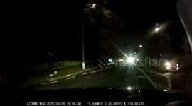 Lucky woman gets out of car into moving traffic