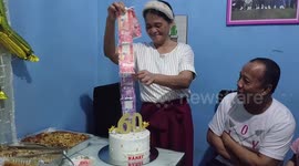 Filipinos surprise their mother with money pulling cake on her 60th birthday