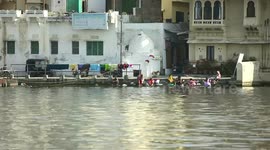 people washing clothes in the river