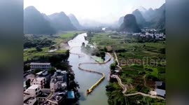 Dozens of bamboo rafts form 800-metre-long dragon on river to celebrate Chinese Valentine's Day