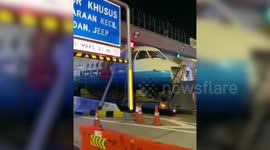 Rare aircraft gets stuck at narrow toll gate when being carried to Indonesian museum