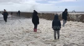 Sea foam on pier at West bay Dorset during Storm Francis