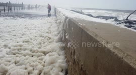 Sea foam whipped up by Storm Francis on pier at West Bay in Dorset