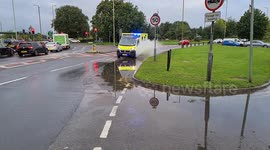 Slow motion Ambulance Splashes Through puddle