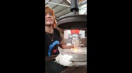 The woman cut the glass cups very quickly