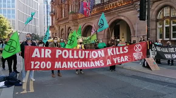 Extinction Rebellion block streets in centre of Manchester, UK