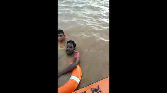 Patrolling officials jump into floodwater to rescue drowning residents in India