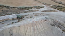 Drone shot of girl marvelling at the beauty of The Bardenas Reales