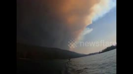 Smoke from Creek Fire engulfs California skyline as family takes dip in nearby lake