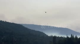 Helicopters picking up water at Bass Lake California to fight the Creek Fire