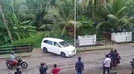 Man parks the car inside small space next to sidewalk in southern India