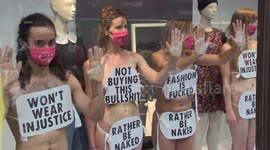 Extinction Rebellion protesters strip off and glue their hands to H&M shop window in London