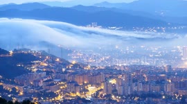 Mesmerising footage as clouds fall from the mountains covering Barcelona in fog before drifting out to the Mediterranean at sunrise