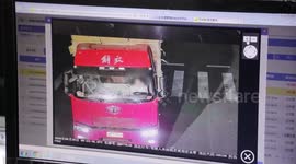 Truck driver holds one-year-old son in arms while driving on road in China