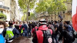 Protesters try to escape police by crossing a tear gas cloud