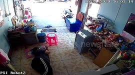Wild monitor lizard runs across woman while she lies down relaxing