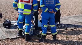 Moment migrant who arrived on a dinghy is treated after becoming ill on the crossing