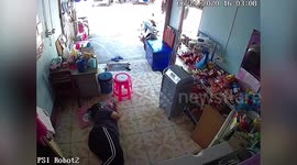 Wild monitor lizard runs across woman's tummy while she lies down relaxing (extended)