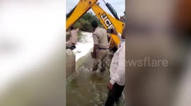 Police in India use digger to rescue pup stranded due to overflowing reservoir