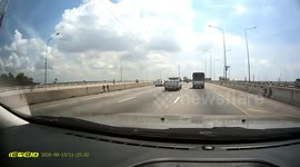 Terrifying moment metal sheet comes loose smashing into car behind