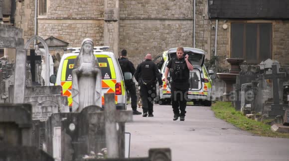 Armed police scour cemetery during manhunt in London