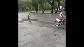 Guys Successfully Enjoying Jetski On The Road With The Help Of Rain Water