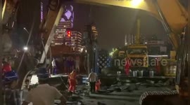 Diggers repair massive open sinkhole on Chinese road