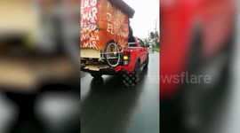 Kind family carries family's tuktuk in his vehicle to help them reach home