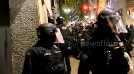 Police detain protester as woman cries in distress during clashes in Portland