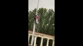 During the protests in Minsk, a black man hung a white-red-white flag on a street lamp