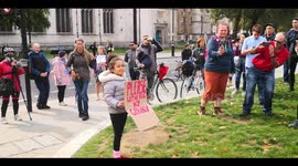 Child holds a let me hug my granny sign