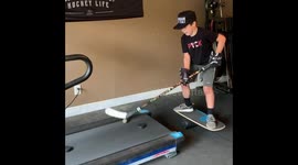 Kid Performing Stick Handling Trick On Treadmill