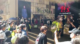 Police stopped and checked a passerby at the shopping mall in Causeway Bay during the China National Day protest.