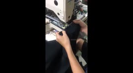 The man sewing buttons very quickly