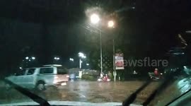 Driving in a tropical storm with thunder and lightning and heavy rain.