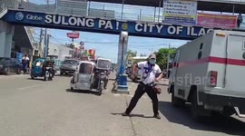 Filipino police officer dances while directing traffic on busy road