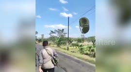 Paratrooper rescued after crash landing on phone lines in Indonesia