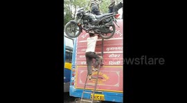 Can you balance a motorbike on your head and climb up a ladder?
