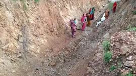 Women dig pathway through hill to bring water to their village in central India