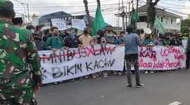 Dozens gather outside presidential palace in Indonesia protesting against government's labour laws