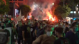 Antifascist protesters light up torches outside neo-Nazi party offices after Greek court rules party leaders guilty of running crime gang