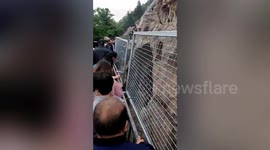 Fence installed to prevent tourists from touching thousand-year-old Buddhist statues in China