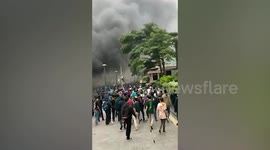 Buildings set alight and police cars attacked during riots in Indonesia