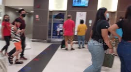 Thai people wearing masks in a shopping center.