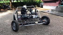 Watch - Young boy designs a car is his backyard using his father old bike motore gine