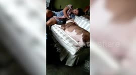 Dog invades sofa and pushes away owner